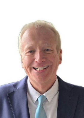 a man in a suit smiling